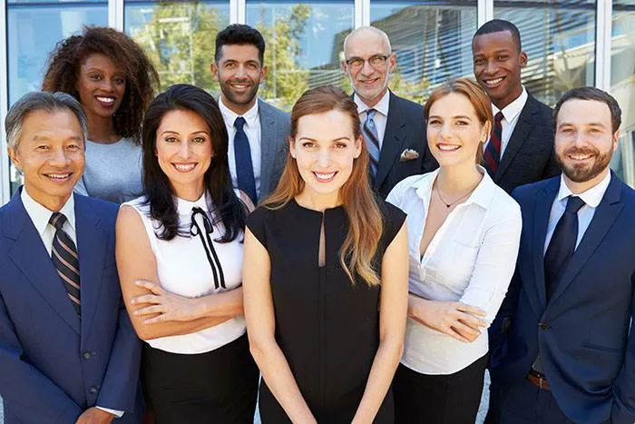 Team of mortgage and real estate professionals standing outside